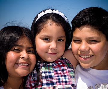 Three students smiling