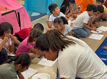 Students working on an activity with a teacher Students working on an activity with a teacher