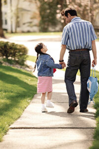 Father walking his daughter to school