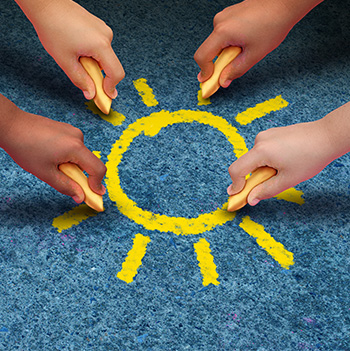 students drawing a sun with chalk