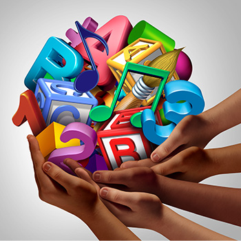 multiple hands holding a pile of educational supplies