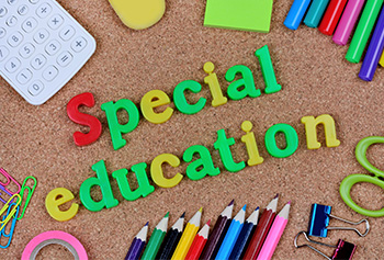 school supplies with letters that spell special education in the center