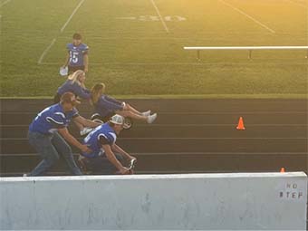 students racing tricycles