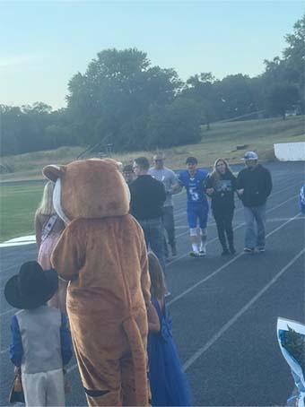 Mascot and staff on track