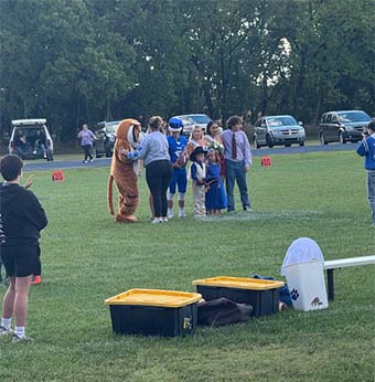 mascot talking to staff