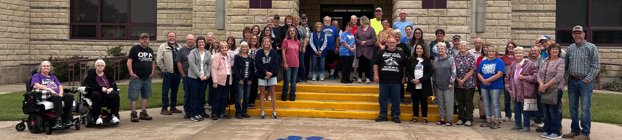 Staff members on building steps