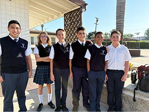 Group of happy students posing for a picture outside campus