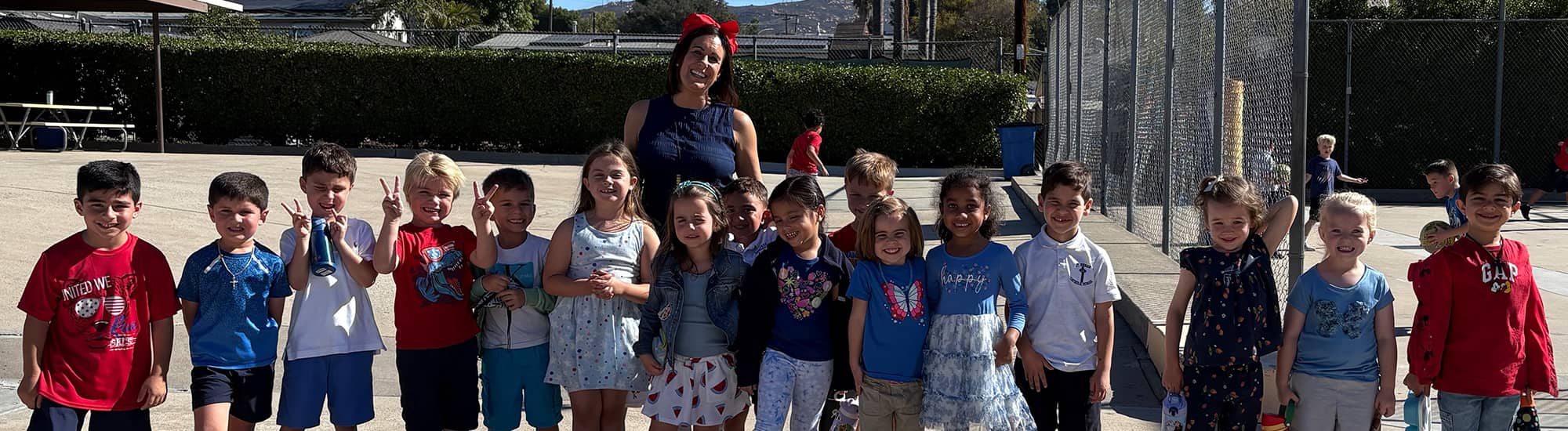 Outside group photo of teacher and class