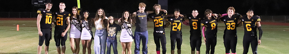 Homecoming courts on the football field