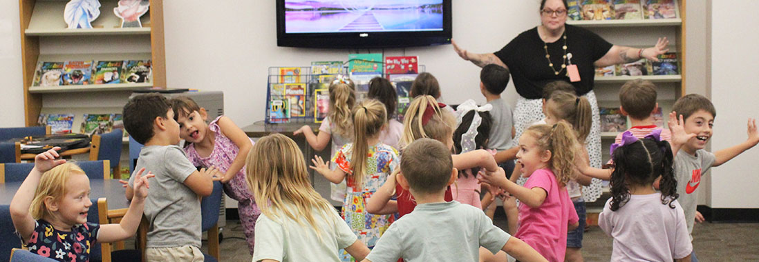 Elementary students having fun in the classroom with their teacher