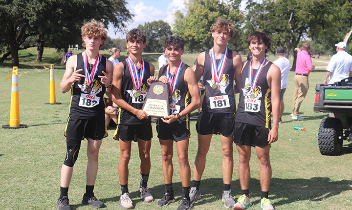 Boys cross country team holding a trophy