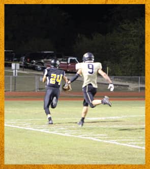 Two football players running on the field