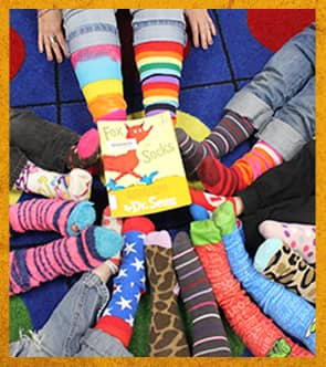 Students with colorful socks with the book Fox for Socks