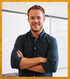 Teacher standing in front of white board