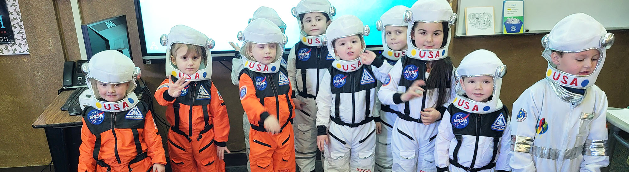 Group of happy Mountain Meadows students dressed as USA astronauts