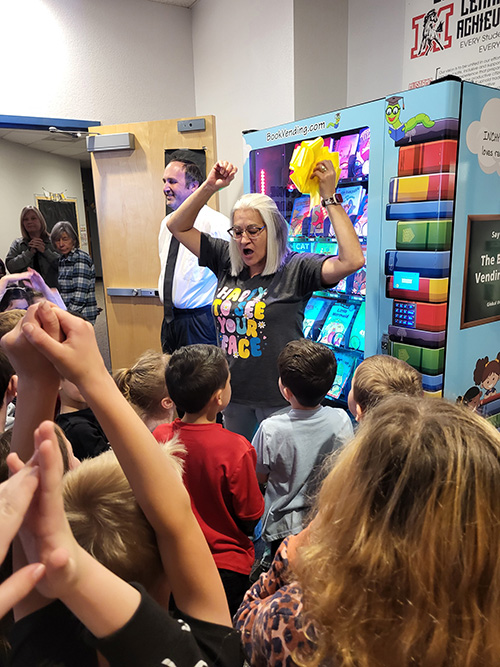 Students learning about the new book machine