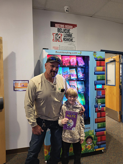Man next to student and new book machine