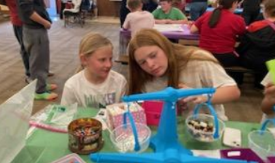 Two students measuring items during STEAM night