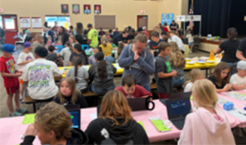 Students in the gym engaged in STEAM activities