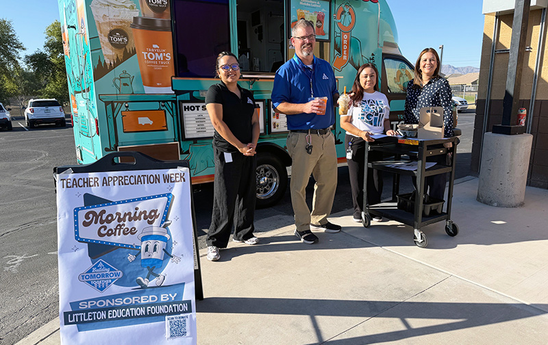 LEF representatives posing for a picture outside with a Morning Coffee Teacher Appreciation truck and banner