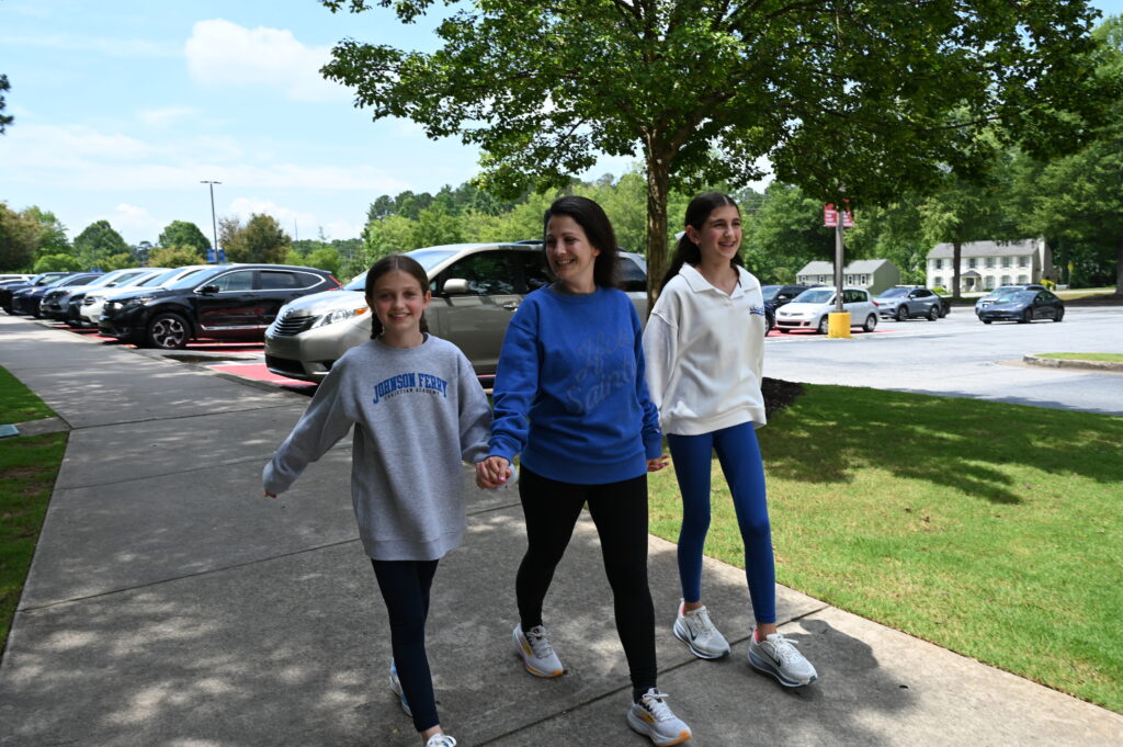 Parent and student walking down school entrance steps
