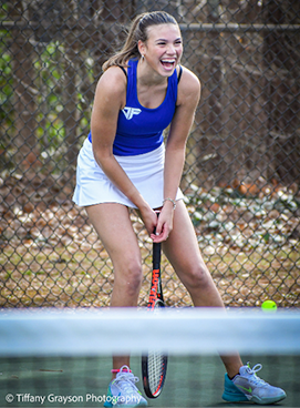 Student playing tennis