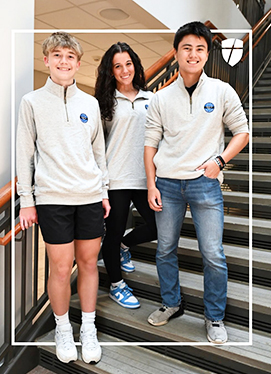 Three happy students wearing spirit wear