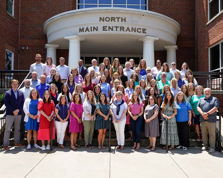 Group of staff outside of the main entrance