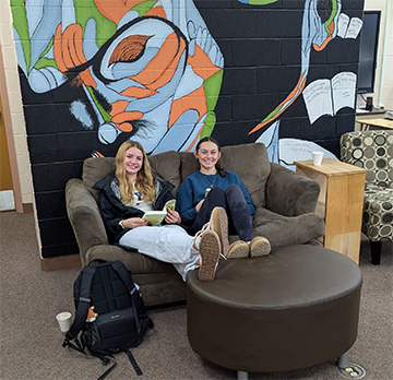 Two students sitting on a couch