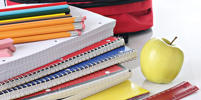 Notebooks, pencils, erasers, backpack, rulers, and an apple