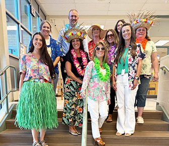 Group of staff members in Hawaiian attire