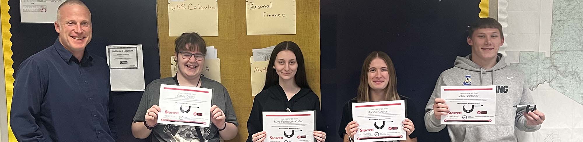 5 people holding paper awards