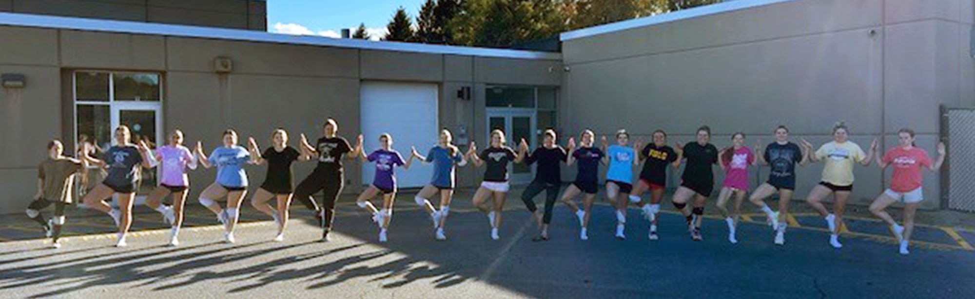 Group of students outside in a line posing for a picture
