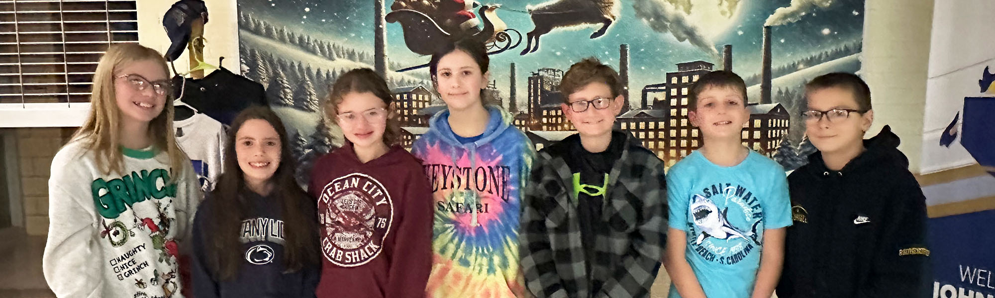 Sixth grade students smiling for the camera as they visit a board meeting