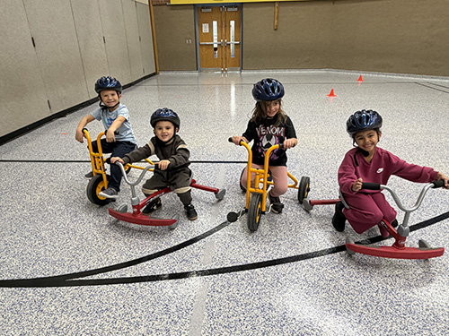 Four Pre–K Students enjoying a bike activity