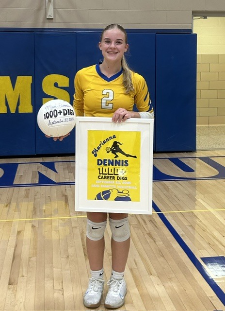 Mari, volleyball player, holding ball and Dennis 1000 poster