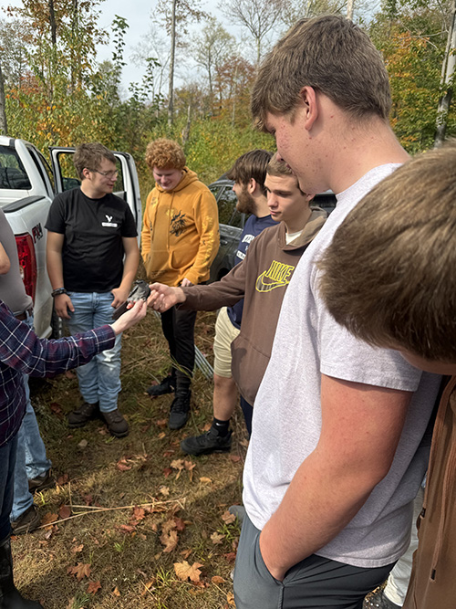 Group of students on a learning enrichment field trip in the forest