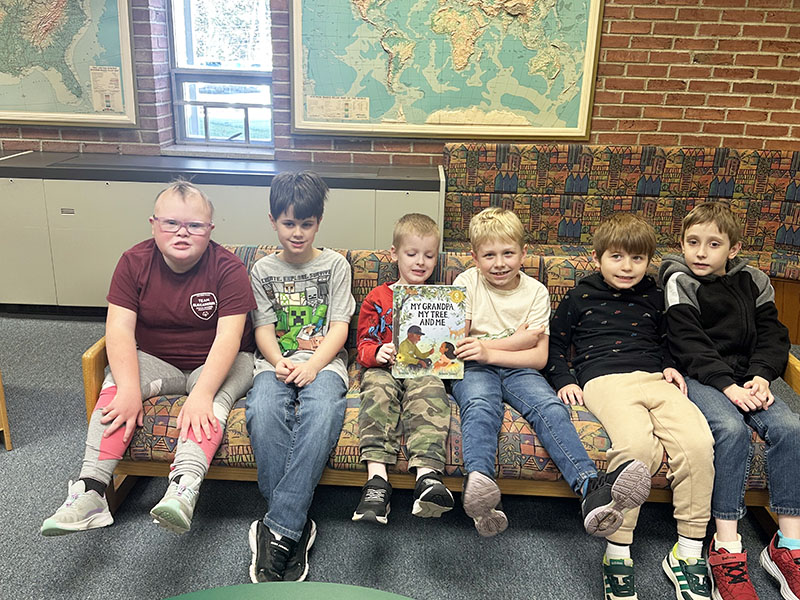 Group of happy students from Mrs. Holmberg's students accepting library books
