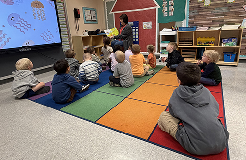 Mrs. Allegretto reading to students