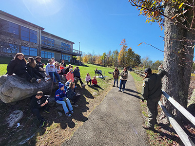 Students outside listening to park ranger presentation