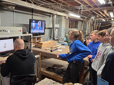 students watching a design being created on a monitor