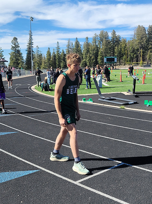 Varsity track runner on the track