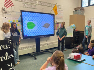 Students giving a presentation about pollution