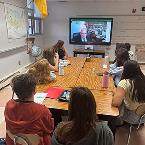 Students watching a speech on TV