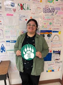 teacher holding an award