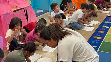 Students working on a rug