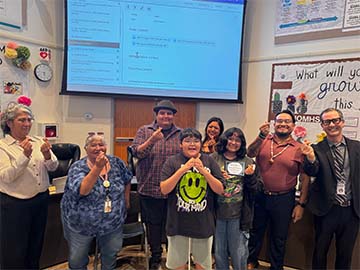 student of the month with staff members