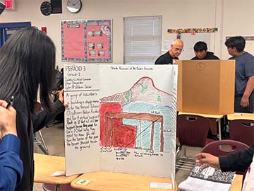 Student showing project at a fair