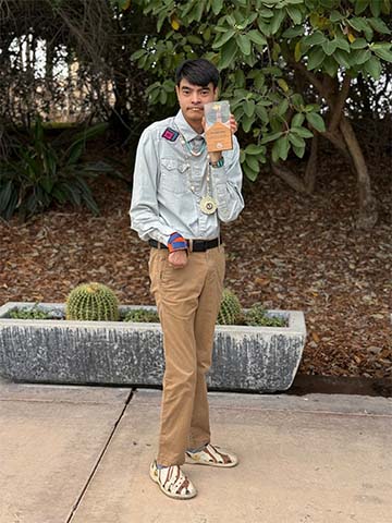 Student holding an award