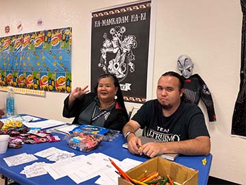 two staff members at a table